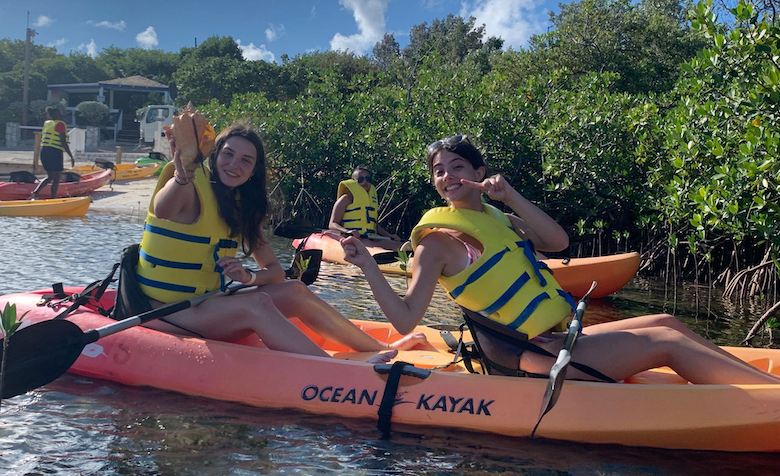 Abby Morgan (left), a senior biology major from Tullahoma, Tennessee, and Bridget Sprandel, a junior biology major from Crystal Lake, Illinois, show off a live conch they discovered while exploring an estuary on the Bahamian island of Half Moon Cay. The Ole Miss students participated in an Island Biogeography course in the Caribbean during the 2022 Wintersession. Submitted photo